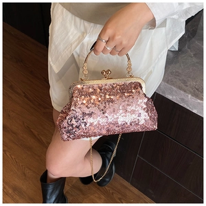 Close-up of pink sequined evening bag with vintage gold clasp and carved metal handle
