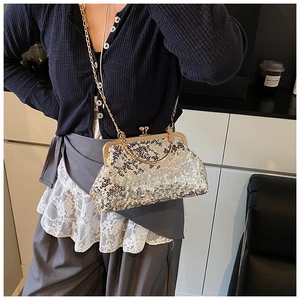 Detail of silver sequined evening bag with gold metal frame and fine chain strap