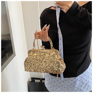 Detail of gold sequin evening clutch with retro metal frame and chain strap