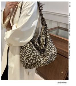 Close-up of leopard print canvas hobo bag with wide shoulder strap and spacious interior