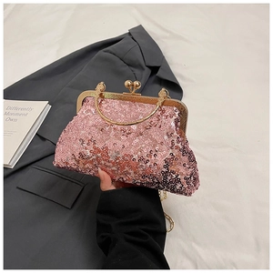 Detail of pink sequin clutch featuring a gold metallic handle and vintage clasp closure