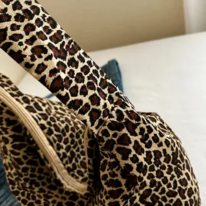 Detail view of leopard print canvas tote with high-quality zipper and woven texture