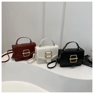 Three minimalist crossbody bags in brown, white, and black with elegant gold square buckles