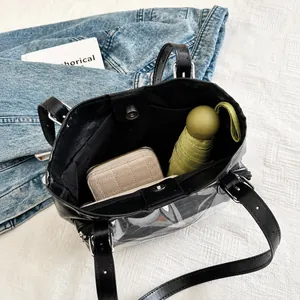 Detail view of large capacity black tote bag showing a wallet and umbrella inside