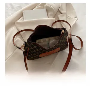 Detail shot of vintage patterned crossbody bag interior showing storage capacity