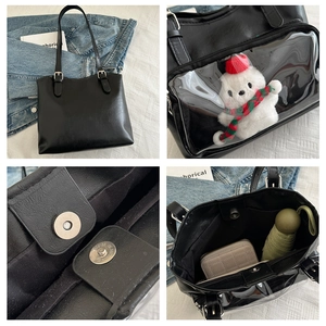 Detail view of large black leather tote with transparent PVC pocket and magnetic buckle