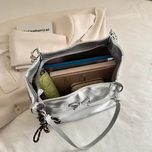 Top-down view of silver tote bag interior showing large capacity for essentials