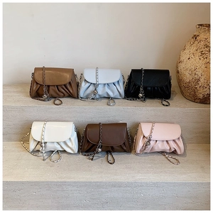 Pleated cloud shoulder bag with chain strap in six colors on stone display