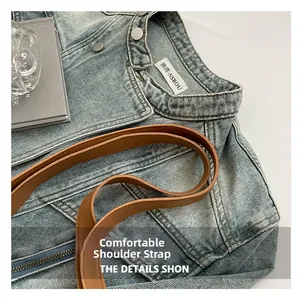 Detailed close-up of blue denim woven bag with high-quality brown leather shoulder strap
