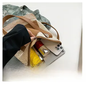 Large straw tote bag interior showing capacity for smartphone, tablet, and cosmetics