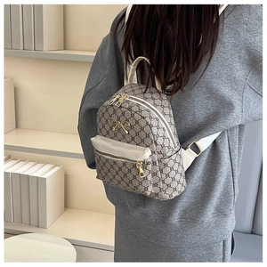 Detailed shot of vintage monogram mini backpack with gold bow and white straps