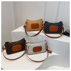 Detail of four monogram leather crossbody bags in yellow, black, brown and white colors