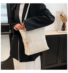 Detail of cream woven tote bag with braided rope strap and textured vertical pattern