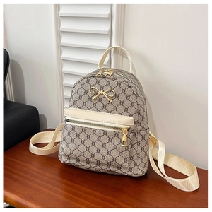 Detail of vintage monogram mini backpack with golden bow hardware and front zipper pocket