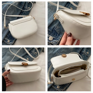 Detail view of cream PU saddle bag showing hardware, strap, and interior compartments
