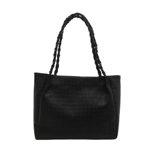 Minimalist black tote bag with houndstooth embossing and braided handles for commute