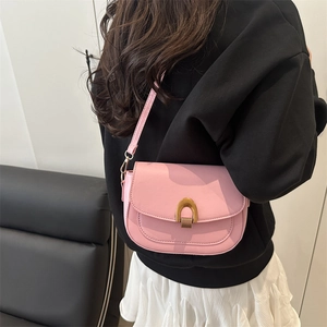 Pink minimalist saddle crossbody bag for women with gold U-shaped metal buckle details