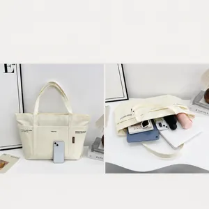 Große weiße Canvas-Einkaufstasche mit geräumigen Fächern für Laptop und Alltagsgegenstände