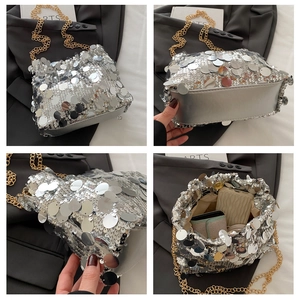 Macro detail of silver sequin bag featuring golden chain strap and spacious interior