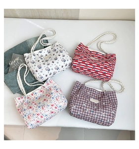Flat lay of four cartoon printed canvas tote bags with rope handles in diverse patterns