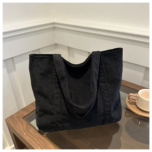 Minimalist black corduroy tote bag with dual handles for daily commute and casual style