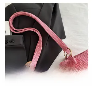 Detail of woven fabric tote bag showing bold metal ring and reinforced handle strap