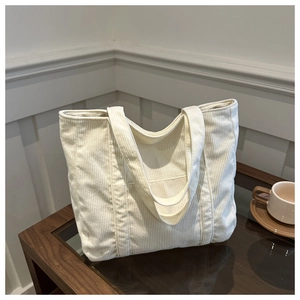 Chic ivory corduroy tote bag with vertical stripes and convenient front pocket design