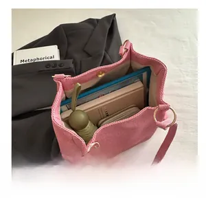 Spacious pink tweed tote bag interior showing capacity for tablets and umbrellas