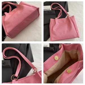 Detail view of pink canvas tote bag showing magnetic closure and golden metal rings