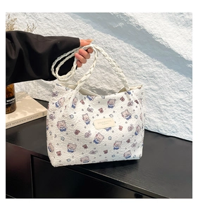 White woven tote bag with colorful cartoon bear print and stylish braided handles