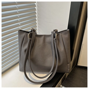 Detailed texture of dark grey canvas tote bag with woven fabric and metal ring strap