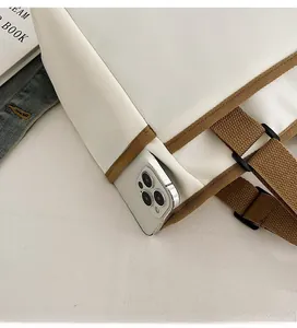 Detailed view of canvas tote side pocket holding a smartphone for easy access