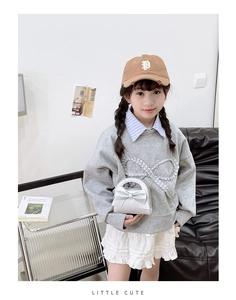 Silver bow shoulder bag styled with grey sweatshirt and white pleated skirt for girls
