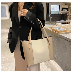 Detail of cream and beige tote bag with gold buckle and Fashion & Bag logo