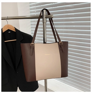 Detailed shot of two-tone tote bag with metal buckle strap and Fashion & Bag text