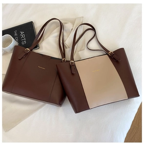 Detail of solid color tote bags with metal buckles and Fashion & Bag gold lettering