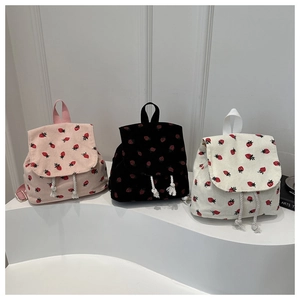 Detailed comparison of corduroy strawberry backpacks in pink, black, and white colors