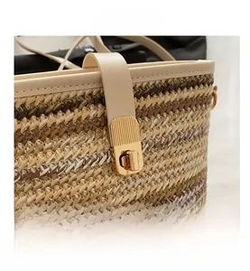Detail of woven fiber texture and golden rectangular twist lock on the crossbody bag