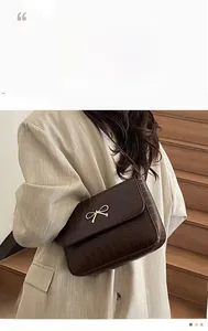 Modelo luce bolso de hombro marrón oscuro con grabado de cocodrilo y lazo dorado