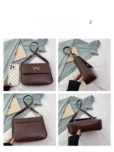 Vue multi-angle d'un sac bandoulière marron foncé à motif crocodile et nœud doré