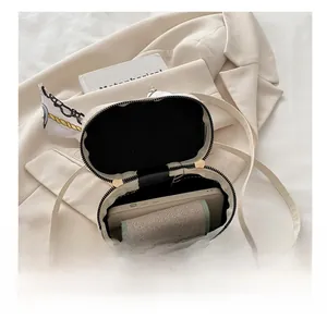 Top view of white cylindrical PU leather bag interior showing phone and wallet storage
