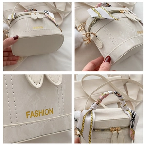 Detailed views of a white cylindrical vanity bag with gold logo and silk scarf handle
