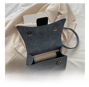 Blue denim crossbody bag interior view showing space for phone and small wallet