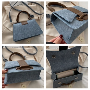 Details van blauwe denimtextuur, bruin leren handvat en interne opbergcapaciteit voor mobiel