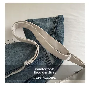 Detail of white nylon bag comfortable leather strap with adjustable silver metal buckle