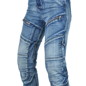 Detailed macro view of blue washed motorcycle jeans with reinforced quilted knee protection