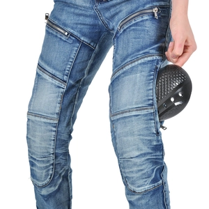 Detail of inserting honeycomb protective pads into blue motorcycle riding jeans pockets