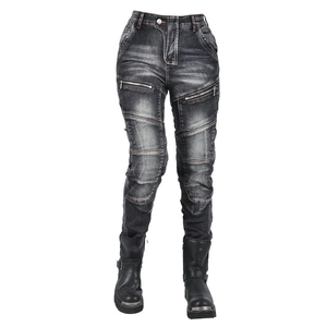 Detail of washed motorcycle jeans with reinforced knee patches and side zipper pockets