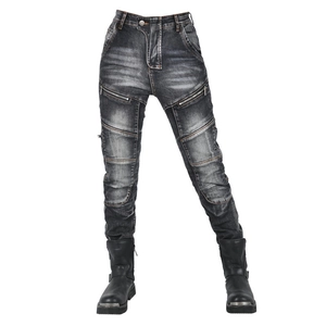 Detail of washed denim motorcycle pants featuring knee patches and metal zipper pockets