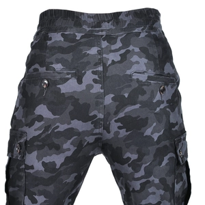 Detail of men's camo riding pants showing elastic waist and buttoned cargo pockets